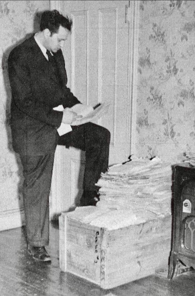 Thomas Wolfe poses with a wooden crate full of his loose pages for Of ‘Time and the River.’