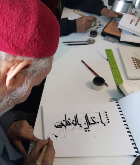 A master artisan showing his work at a contemporary Muslim calligraphy school