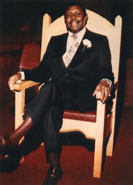 1975 photo of the Reverend C.L. Franklin sitting in a chair