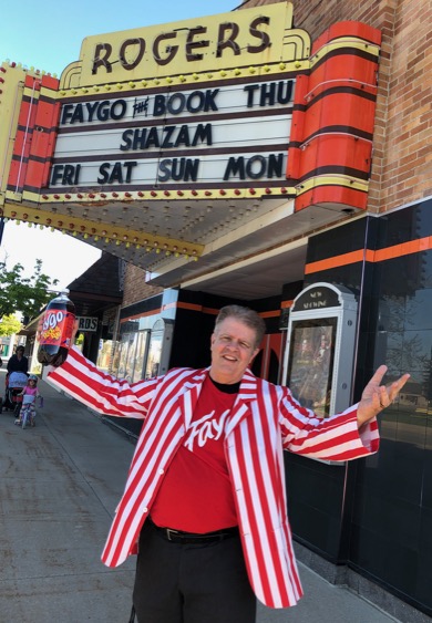 Joe Grimm with a 2-liter of Faygo in front of Rogers City Theater
