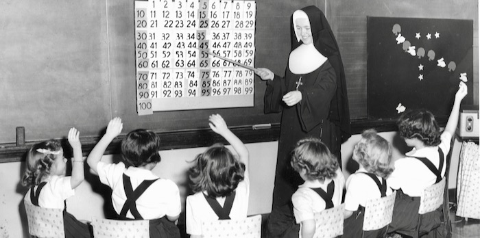 IHM Sister Kathleen Mary O’Brien Teaches 49 1st and 2nd Graders at Our Lady of Mount Carmel in Emmett, Michigan circa 1958